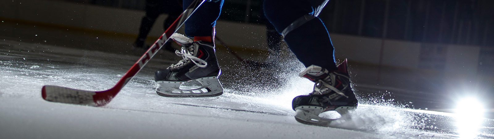 Northland hockey player hitting the puck.