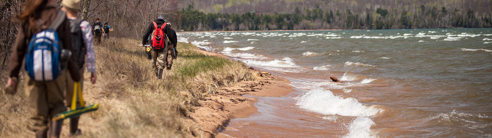Students hike along beach