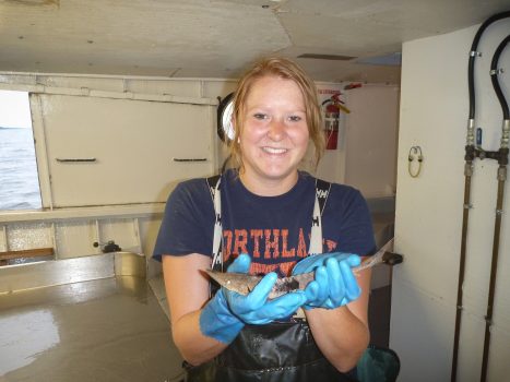 Northland College holds baby sturgeon as part of internship