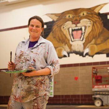 Photo of Cait Irwin and mural painting