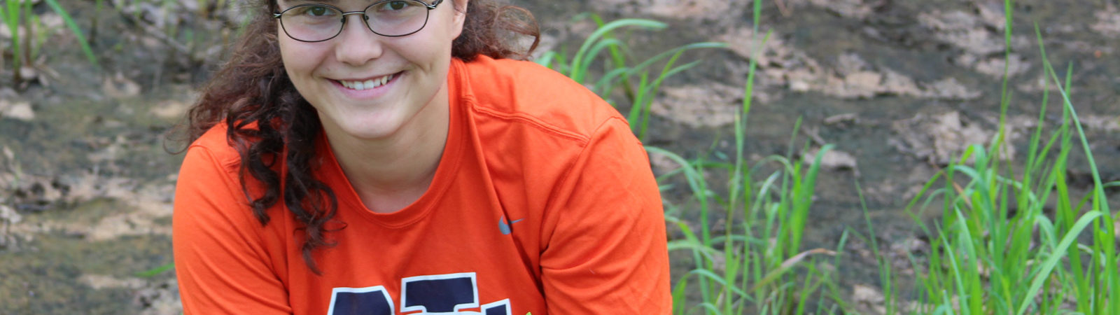 Northland College student Erin Bergen assists with planting a native garden.