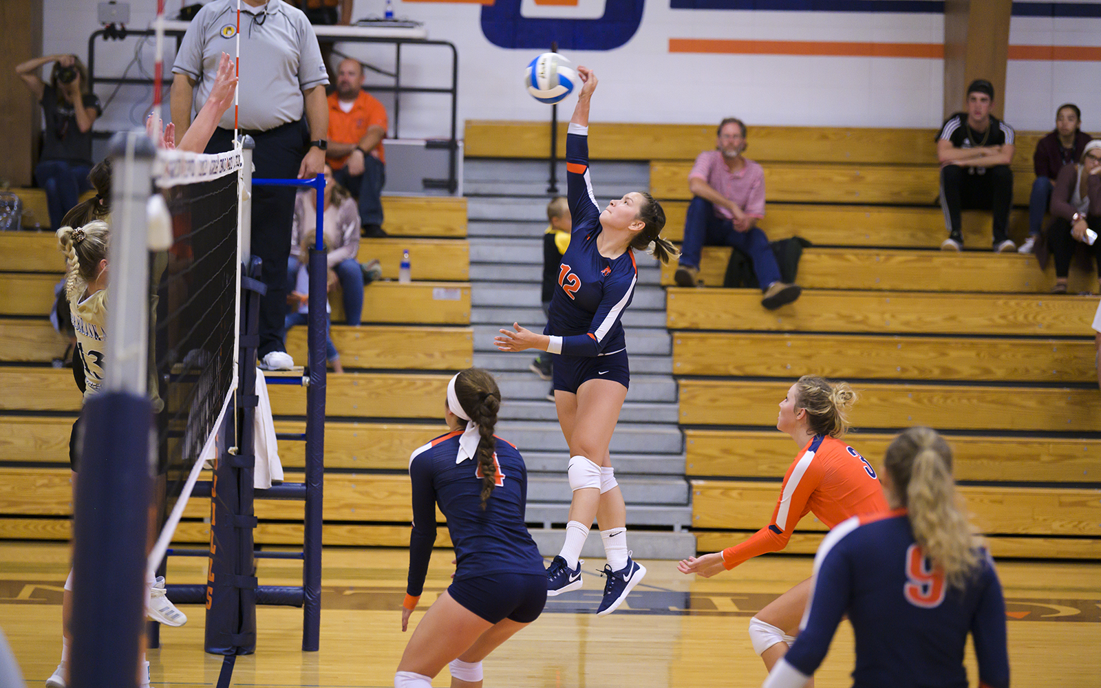 Northland College volleyball player spikes the ball