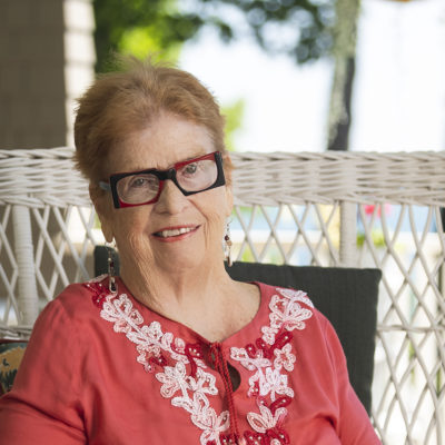 Northland College Trustee Mary H. Rice on her porch in Bayfield.