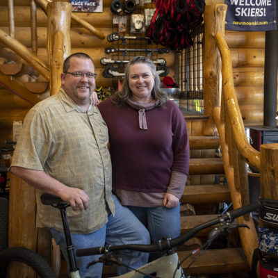 Portrait of alums Chris and Judy Young '93 at New Moon Ski and Bike Shop.