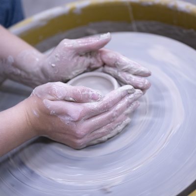 Northland student hands creating a bowl in ceramics.