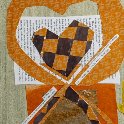 A closeup of the cover art for Northland College Magazine’s Fall 2021 issue. Cut-out shapes of hearts are layed over a book page and a grey-beige, textured surface. Two lines from a book page have been cut out and are next to the heart shapes.