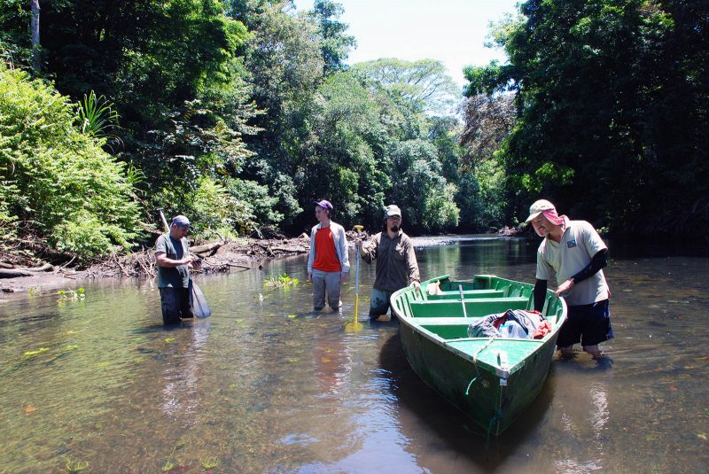 Researchers and their boat in a river in Costa Rica