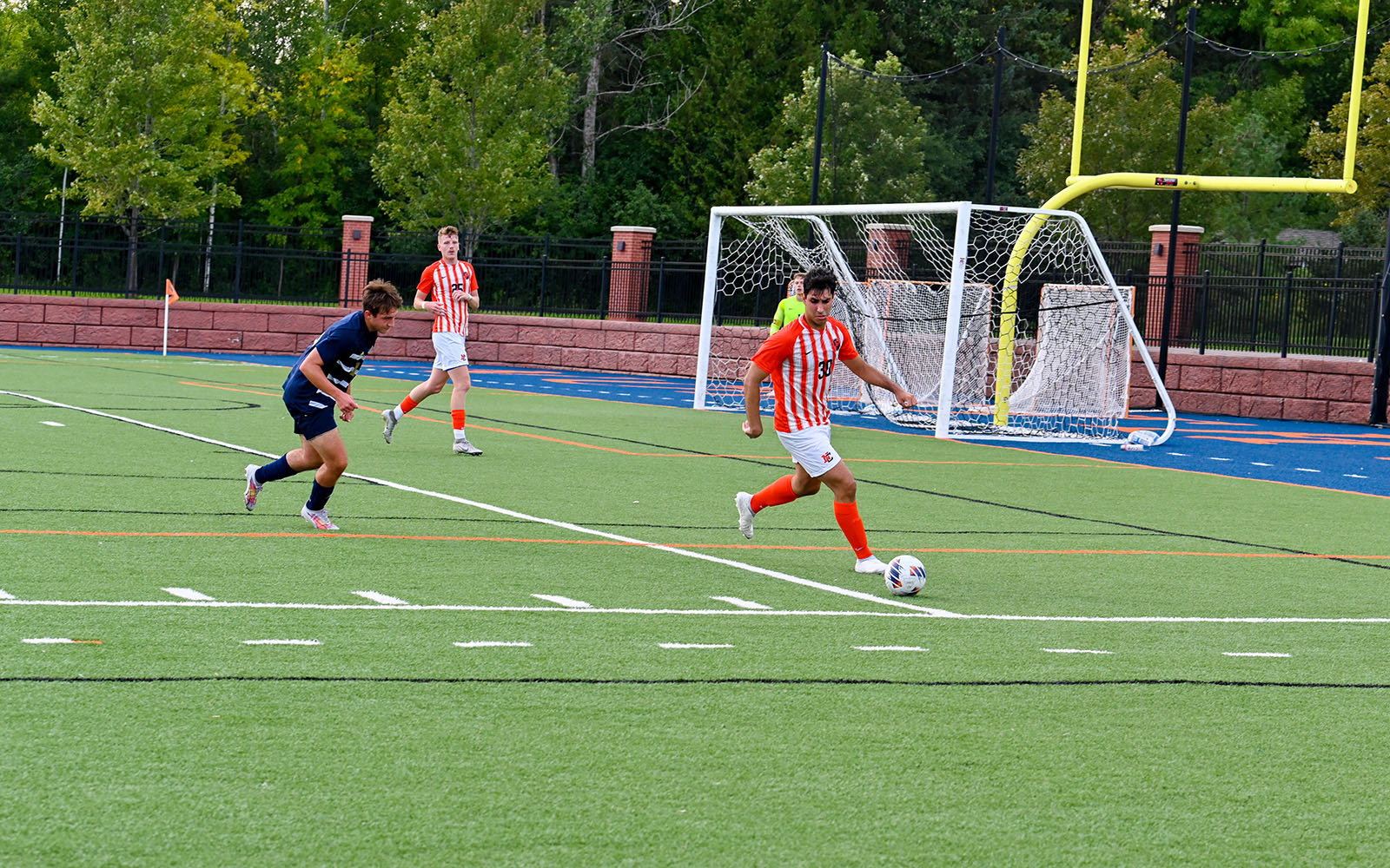 LumberJack athlete with a soccer ball during a game.