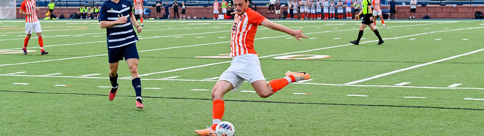men's soccer: player kicking the ball