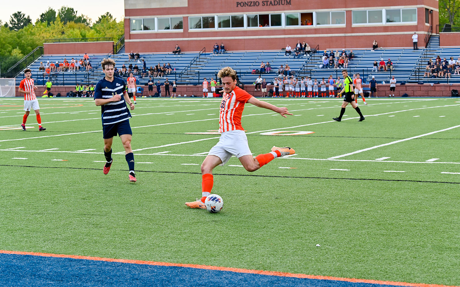 men's soccer: player kicking the ball