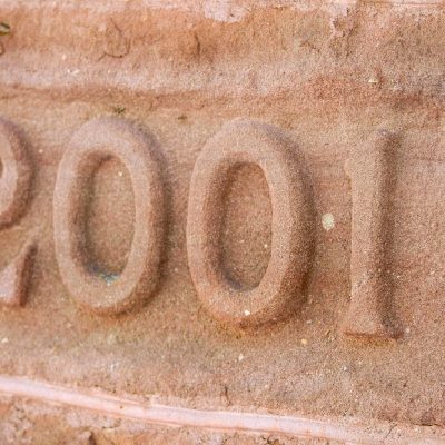 The class year 2001 carved into one of the stones at the base of Wheeler Hall