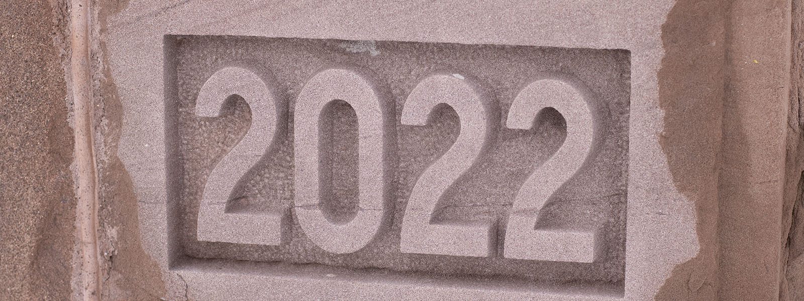 The class year 2022 carved into one of the stones at the base of Wheeler Hall