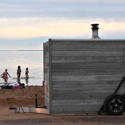 Students head back toward the shore of Lake Superior after spending time in the sauna on shore